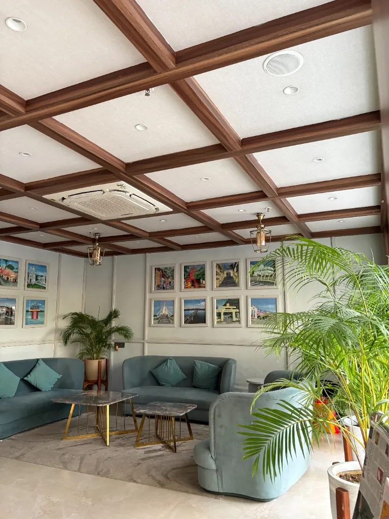 Lounge Gallery — Soft seating under a coffered wood ceiling