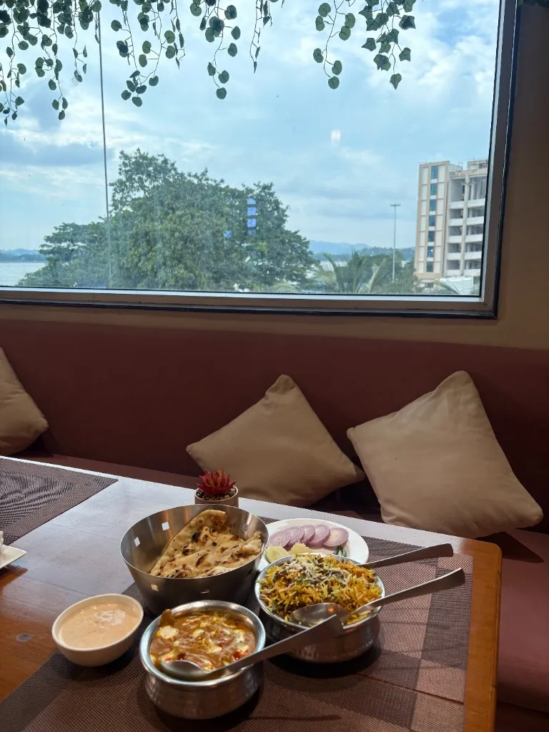 Table With a View — Biryani, curry and naan by the window