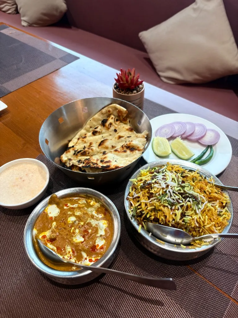 North Indian Feast — Biryani, creamy curry, naan and raita